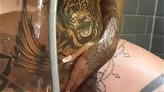 Busty Tattooed MILF Tyra Drenches Herself with Shower Head