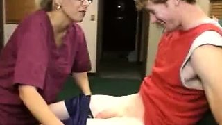 Milf Carey Riley strokes a young guys dick in the office