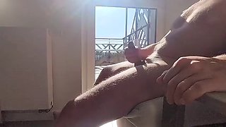 Dickflash in a hotel where a maid comes through the balcony and gets cum on her tits