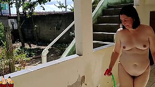 Naked housewife cleaning the balcony