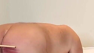 Young domme canes her slave