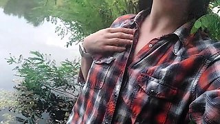 Brunette teen masturbates by the lake