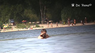 Beach nudist couple having sex in water on voyeur cam
