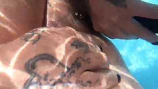 Camilla and Cheyenne Play with a double ended dildo in the pool