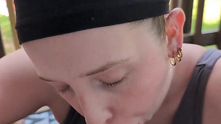 Blonde beauty giving a wet blowjob on the patio