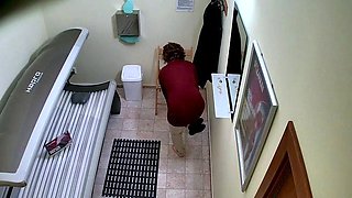 Busty brunette in solarium